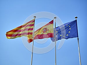 Flags of Catalonia, Spain and European Union waving.