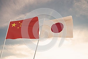 Flags of China and Japan waving with cloudy blue sky background, 3D redering United States of America, Chinese Communist Party CCP