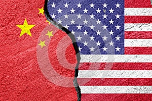 Flags of China and the United States of America on a cement plaster of a cracked wall as a concept of escalation and tension in