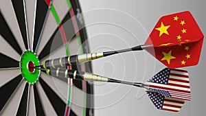 Flags of China and the USA on darts hitting bullseye of the target. International cooperation or competition conceptual