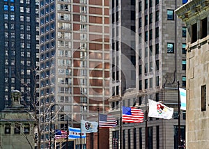 Flags of Country, State and City fly over bridge on Michigan Avenue, Chicago.