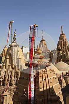 Flags and detail reliefs on rooftops of Jain temple in Jaisalmer, India