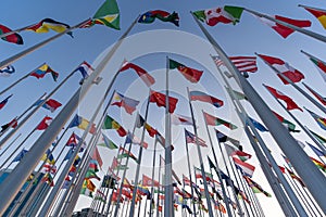 Flags of the different countries against the blue sky