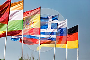 Flags of different countries against the blue sky