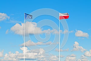 Flags of European Union and Poland on the blue sky