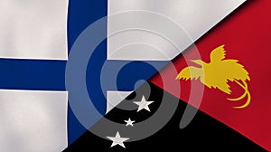 The flags of Finland and Papua New Guinea. News, reportage, business background. 3d illustration