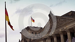 Flags flying outside Reichstag or Deutscher Bundestag German Parliament building in Berlin, Germany