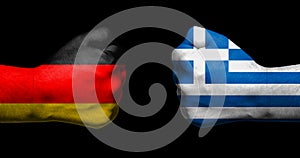 Flags of Germany and Greece painted on two clenched fists facing