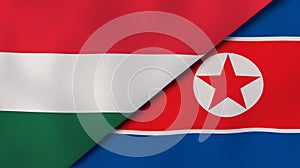 The flags of Hungary and North Korea. News, reportage, business background. 3d illustration