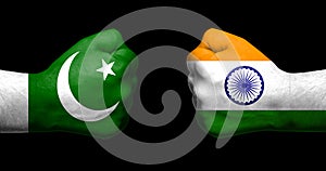 Flags of India and Pakistan painted on two clenched fists facing photo