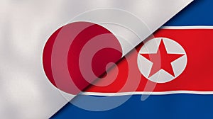 The flags of Japan and North Korea. News, reportage, business background. 3d illustration