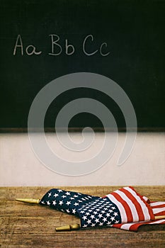 Flags laying on top of old school desk