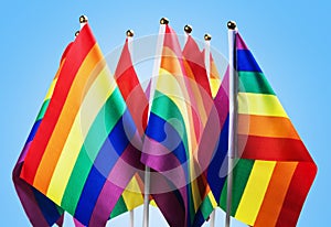 Flags of the LGBT community on a blue