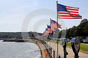 Flags-lined embankment of the Western Harbor at Stacy Blvd, Gloucester, MA, USA