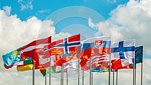 Flags. Many bright flags develop in the wind against the sky. Denmark, Latvia, Finland and others