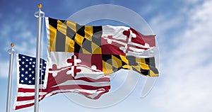 Flags of Maryland and of the United states waving in the wind on a clear day