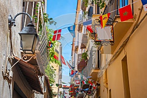 Flags in a narrow alley in old town Sorrento