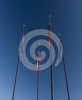 Flags and no wind near Bratislava castle in evening with blue sky in Slovakia