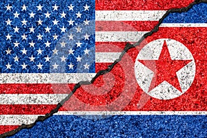 Flags of North Korea and USA painted on cracked wall background/North Korea versus USA conflict concept