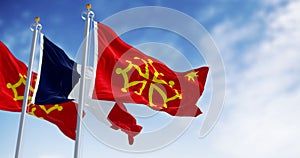 Flags of Occitanie region and France waving in the wind on a clear day