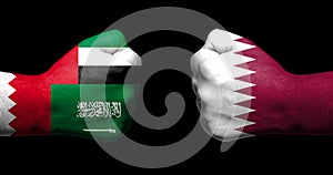 Flags of Qatar and its neighbours painted on two clenched fists