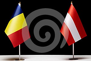 Flags of Romania and Austria on table, concept of bilateral and diplomatic relations. European countries negotiations and agreemen