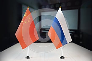 flags of russia and china international negotiations. conclusion of contracts between countries. concept of communication between photo