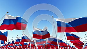 Flags of the Russian Federation waving in the wind against blue sky
