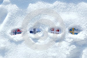 Flags of the Scandinavian countries in the snow. Stuck in the snow flags of Norway, Denmark, Sweden, Finland.