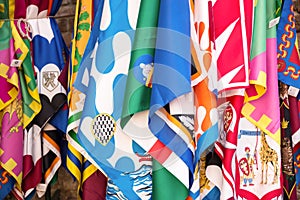 Flags of the Siena contrade districts, Palio festival background, in Siena, Tuscany Italy