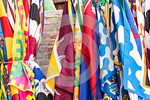 Flags of the Siena contrade districts Palio festival background, in Siena, Tuscany, Italy