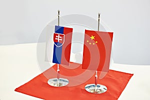 Flags of Slovakia and China on table