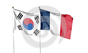 Flags of South Korea and France against the cloudy sky