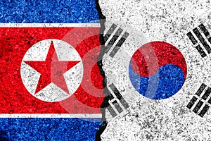 Flags of South Korea and North Korea painted on cracked wall background/South Korea versus North Korea conflict concept