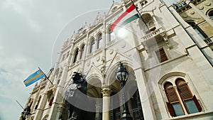 Flags sway in the wind at the Hungarian Parliament building in Budapest