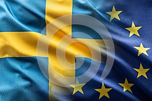 Flags of Sweden and EU blowing in the wind photo