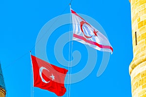 Flags of Turkey and Republic of Northern Cyprus waving between steeples of Selimiye mosque at Lefkosa, Cyprus