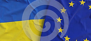 Flags of Ukraine and EU. Linen flags close up. Flag made of canvas. Ukrainian. European Union. National symbols. 3d illustration