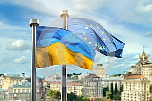 Flags of Ukraine and European Union against Kyiv on background