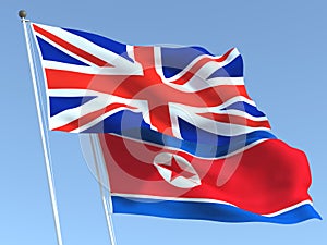 The flags of United Kingdom and North Korea on the blue sky. For news, reportage, business. 3d illustration