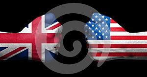 Flags of United Kingdom and United States painted on two clenched fists facing each other on black background/USA-UK relations con