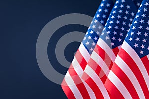 Flags of the United States of America against blue background with copy space