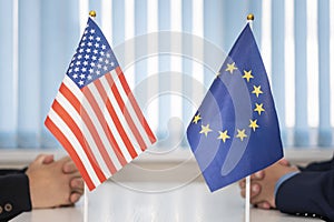 flags of United States and European Union. international negotiations. conclusion of contracts between countries. concept of photo