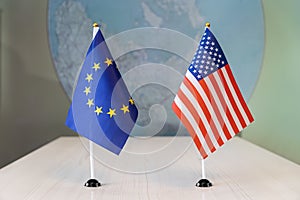 flags of United States and European Union. international negotiations. conclusion of contracts between countries. concept of photo