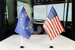 flags of United States and European Union. international negotiations. conclusion of contracts between countries. concept of photo