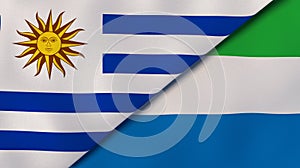 The flags of Uruguay and Sierra Leone. News, reportage, business background. 3d illustration