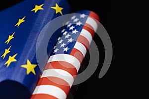 flags of the USA and European Union on a black background. The concept of interaction or counteraction between the two countries.