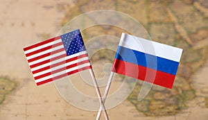 Flags of the USA and Russia over the world map, political leader countries concept image