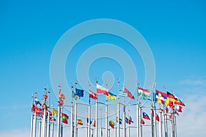 Flags of the world on flagpoles, copy space