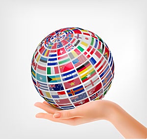 Flags of the world on a globe, held in hand.